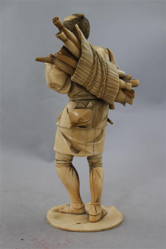 A Japanese sectional ivory figure of a farmer, 21.5cm